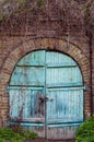 Old Wooden Door In A Brick Wall As A Background. Blue Wooden Door.