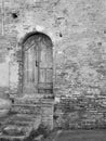 Old wooden door in old brick wall. Black and white photo Royalty Free Stock Photo