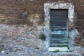 Old wooden door on a brick wall. Left side space Royalty Free Stock Photo