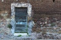 Old wooden door on a brick wall. Right side space Royalty Free Stock Photo