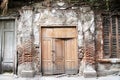 Old wooden door, brick wall, wild roots Royalty Free Stock Photo