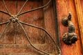 Old wooden door with bronze knocker Royalty Free Stock Photo