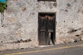 Old wooden door on building ruin facade , abandoned house ,