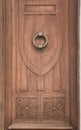 Old wooden door with carved details and door knocker Royalty Free Stock Photo