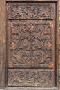 Old wooden door with carved patterns Royalty Free Stock Photo