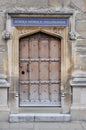Old wooden door close-up within Old Bodleian Library Courtyard, Oxford, United Kingdom
