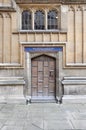 Old wooden door close-up within Old Bodleian Library Courtyard, Oxford, United Kingdom