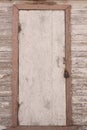 An old wooden door with a closed iron padlock Royalty Free Stock Photo