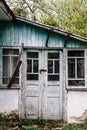 Old wooden door closed on the lock. Peeling paint. Closed on hinges. House. The old door.Part of the old house.Paint blue and Royalty Free Stock Photo