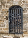 Old wooden door closed by a metal lattice