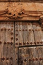 Old wooden door and coat of arms of the Holy Inquisition