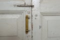 Old door, pen, vintage, paint, white, wallpaper, bolt, copper handle, valve, house, room, wooden Royalty Free Stock Photo