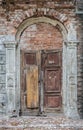 Old wooden door in a destroyed brick building