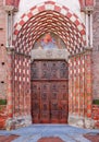 Old wooden door at the entrance to catholic church. Royalty Free Stock Photo