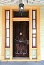 Old wooden door on the facade of a house in the old town. Copper elements and painted doorway