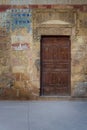 Old wooden door framed by bricks stone wall, Old Cairo, Egypt