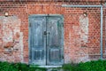 Old wooden door in front of a red brick wall Royalty Free Stock Photo