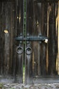 Old wooden door gates with metallic padlock