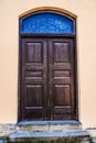 Old wooden door with glass in ancient building Royalty Free Stock Photo