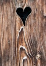 Old wooden door with a heart-shaped hole Royalty Free Stock Photo