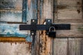 Old wooden door with a heavy lock Royalty Free Stock Photo