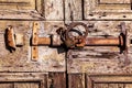 Old wooden door with iron rusty latch and padlock Royalty Free Stock Photo