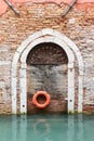 Old wooden door with lifebelt in Venice( Italy) Royalty Free Stock Photo