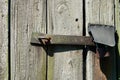 Old wooden door locked with a padlock.
