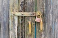 Old wooden door with locked padlock and old handles. Royalty Free Stock Photo