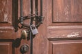 old wooden door locked with rusty chain death lock. closed abandoned house nobody living, people leave and sale home Royalty Free Stock Photo