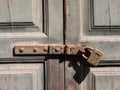 Old wooden door locked with rusty latch and  padlock Royalty Free Stock Photo