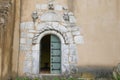 Old wooden door with marble stone frame, unique church entrance Royalty Free Stock Photo