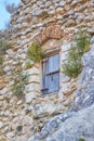 Old wooden door in a masonry wall attached to a piece of rock Royalty Free Stock Photo