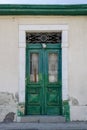 Old wooden door with metal grates