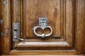 Old wooden door with metal handle knocker Royalty Free Stock Photo