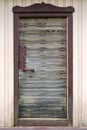 Old wooden door with metal handle, lock and old rusted planks Royalty Free Stock Photo