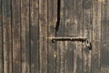 Old wooden door with metal locking bar