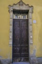 Old wooden door with number on the yellow wall in old town. European building exterior Royalty Free Stock Photo