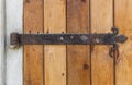 Old wooden door with an old cast iron door hinges Royalty Free Stock Photo