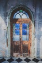 Old wooden door.In the old wall is made of cement. Royalty Free Stock Photo