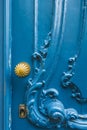 Old wooden door with ornaments and golden doorknob Royalty Free Stock Photo