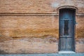 Old wooden door in a red brick wall as background for text Royalty Free Stock Photo