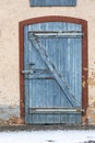 Old wooden door with red frame, very used with weather and age tracks and two locks secured in vertical format Royalty Free Stock Photo