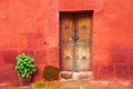 Old wooden door on the red wall Royalty Free Stock Photo