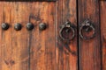 Old wooden door with round iron knockers