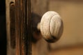 Old wooden door with a round knob, close-up Royalty Free Stock Photo