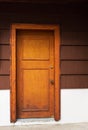 Old wooden door. Wooden front door of an upscale home. View of a wooden front door on a rustic house. Vertical shot Royalty Free Stock Photo