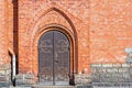 Old wooden door, rusty hinges and lock, brick wall Royalty Free Stock Photo