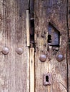 Old wooden door with rusty iron locks Royalty Free Stock Photo