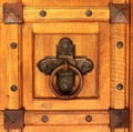 Old wooden door with rusty iron ring doorknocker